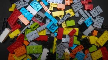 Plastic toy block on a black background photo