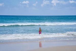 Mahe Seychelles 02.02.2023 Clients on the beach standing in the water photo