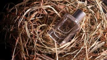 Perfume on dry grass Transparent bottle with perfume video