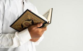 person reading the Quran book photo