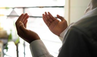 Man rises the hands for praying photo