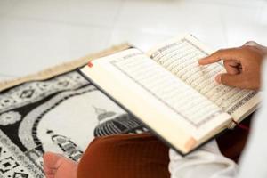 Man reading the holy Quran in islamic concept photo