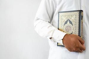 Man holding Quran book for copy space photo