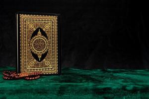 vintage Quran book cover with rosary photo