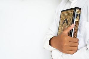 Man hug the holy Quran for copy space photo