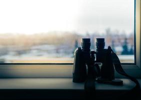 binoculars stand on the ledge of the window photo