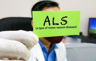 ALS or Amyotrophic lateral sclerosis a type of motor neuron disease, medical conceptual image. Doctor holding a card with medical term. photo