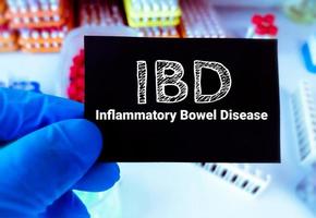 IBD or Inflammatory Bowel Disease term on a card in doctor hand. Medical concept. photo