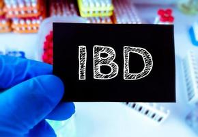 IBD or Inflammatory Bowel Disease term on a card in doctor hand. Medical concept. photo