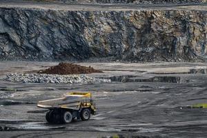 Dump truck in limestone mining, heavy machinery. Mining in the quarry. photo