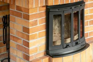 Fireplace, detail of home interior. Fireplace covered with fireclay bricks. photo