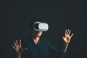 Woman with glasses of virtual reality. Future technology concept. Metaverse technology concept. VR virtual reality goggles. Futuristic lifestyle. female using virtual reality headset at home office. photo