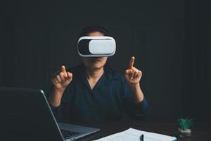 Woman with glasses of virtual reality. Future technology concept. Metaverse technology concept. VR virtual reality goggles. Futuristic lifestyle. female using virtual reality headset at home office. photo