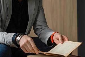 A man in the office at the table reads books. world book day photo