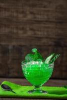 granite dessert, frozen juice of fresh cucumber and mint on a wooden background, minimalism. Summer coolness, tonic ice cocktail, green drink, St. Patrick's day photo