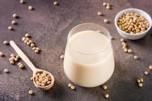 Glass of soy milk and soy beans on the table. Vegetable protein. photo