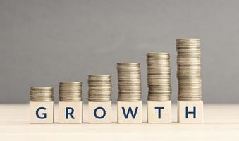 Money or revenue Growth concept. Text on Wooden blocks and Stacking coins. Copy space photo