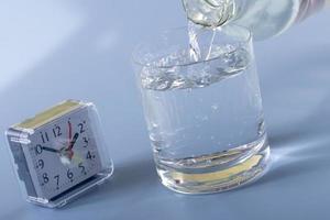 Detail of person filling glass of water. hydration concept photo