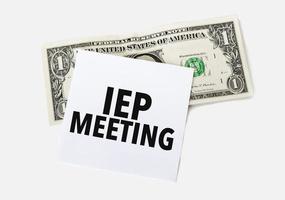 dollar with white card and text iep meeting photo