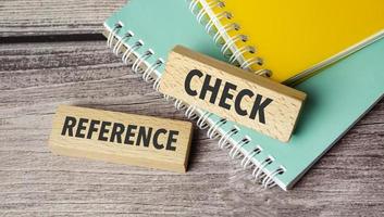 REFERENCE CHECKS symbol. Concept words content is king on wooden blocks. photo