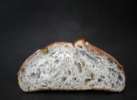 Studio shot, Close up Side view inside of baked brown sourdough natural yeast, artisan, dark background with copy space photo