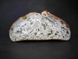 Studio shot, Close up Side view inside of baked brown sourdough natural yeast, artisan, dark background with copy space below photo