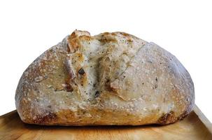 Close up Side view of baked brown sourdough with ear on the wooden plate, natural yeast, isolated, cutout, transparent, with clipping path