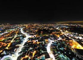 Illuminated Night View of Da Lat City, Vietnam A Captivating Display of City Lights against the Dark Starry Sky photo