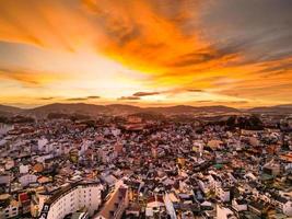 Radiant Sunset Skyline Captivating Red Sky View of Da Lat City, Vietnam with a Stunning Blend of Colors between Cityscape and Sky at Dusk photo