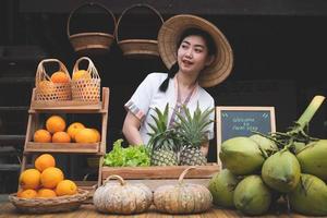 Indigenous Asian women with a natural assortment of fruits welcome tourists at the farm stay. Homestay in Thailand photo