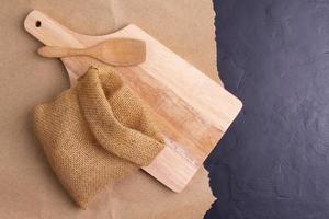 empty wheat flour sacks With wooden chopping boards on the table, black background - top view photo