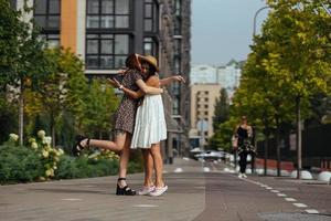 Happy meeting of two friends hugging in the street photo