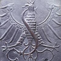 Close up fragment of medieval metal doors with eagle and snake, Poland. Part of antique old door photo