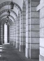 The arched stone colonnade with lanterns concept photo. Urban architectural photography. photo