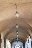 The arched yellow stone colonnade with lanterns concept photo. photo