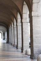 Closeup arched stone colonnade with lanterns concept photo. Urban architectural photography. photo