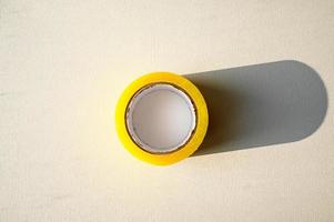 The adhesive tape is insulated. Yellow roll of scotch tape photo