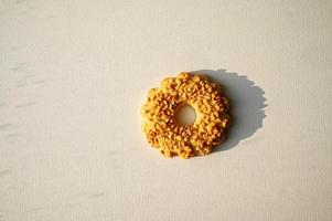 Sand ring with nuts, isolated. Two cookies in the shape of a ring, sprinkled with peanuts. White background photo