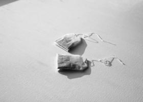 A tea bag with a label. Isolated on a white background photo