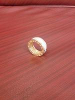 Gold ring on red table photo