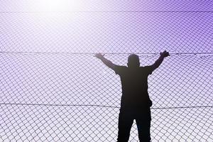 Bilbao, Vizcaya, Spain, 2023 - man climbing the metal fence photo