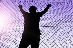 Bilbao, Vizcaya, Spain, 2023 - man climbing the metal fence photo