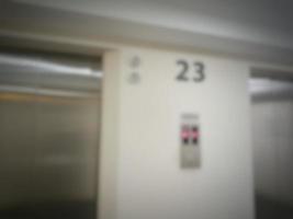 Defocused blurred photo of elevator corridor on floor 23 in a high rise building.