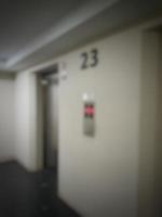 Defocused blurred photo of elevator corridor on floor 23 in a high rise building.