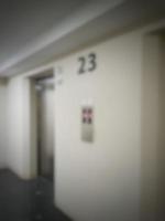 Defocused blurred photo of elevator corridor on floor 23 in a high rise building.