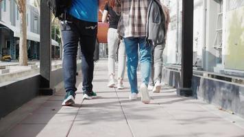 close-up of leg of Group of diverse attractive casual students walking and talking on walkway video