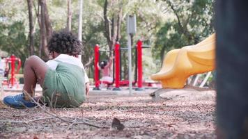 Little boy digging sand in sandbox in playground in park video