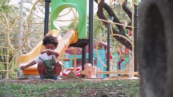 Healthy active baby outdoors plays toy and sand in a sandbox area in playground video