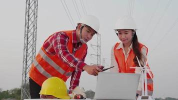 Two Electricity engineers meeting with blueprint of high-voltage power. Teamwork, Leadership video