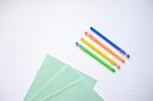 A set of stationery on a white background, pens of different colors photo